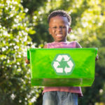 Boy carrying a recycle trash Paper is recyclable, and we can make loads of new products with old paper.